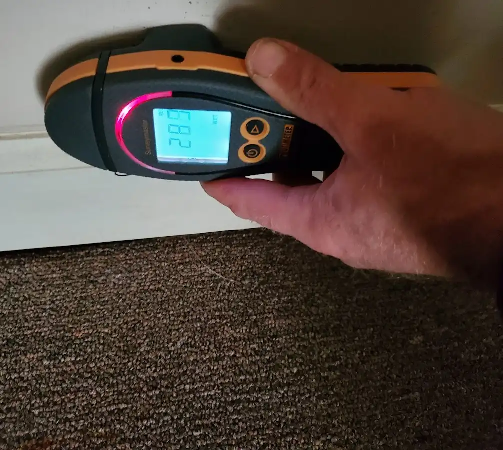 Moisture detection at baseboard during Storm Damage Restoration in South Riding